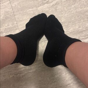 Worn smelly plain black Socks can be worn high or low.